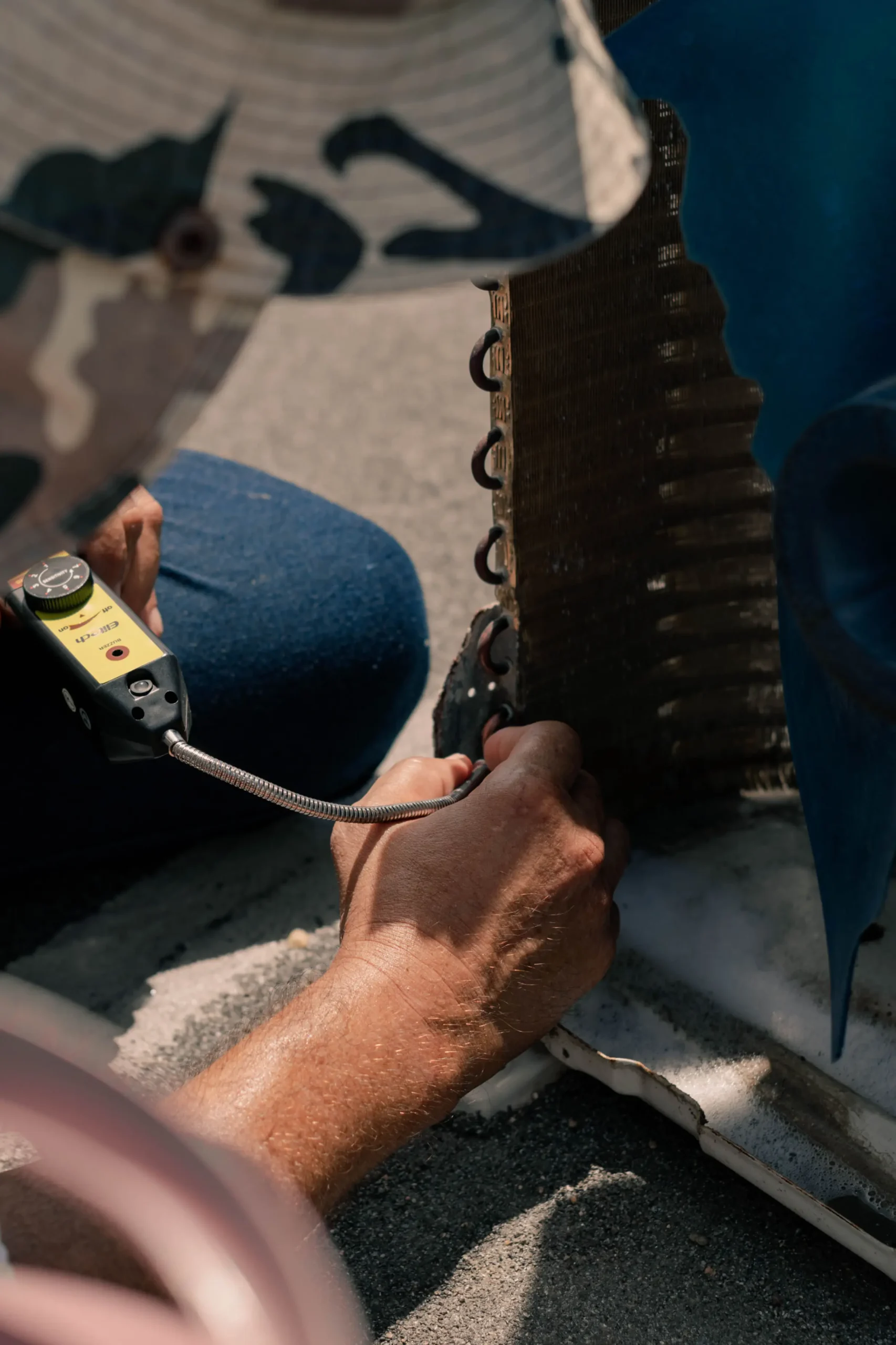 Air conditioning system components being inspected for cooling problems