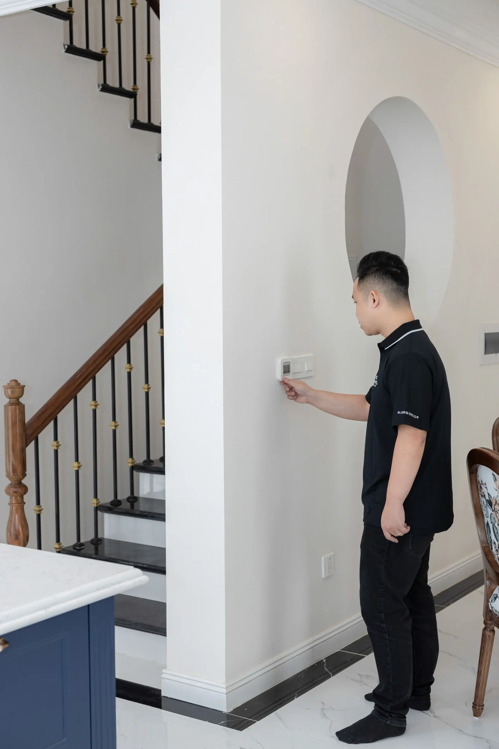 Homeowner adjusting a thermostat