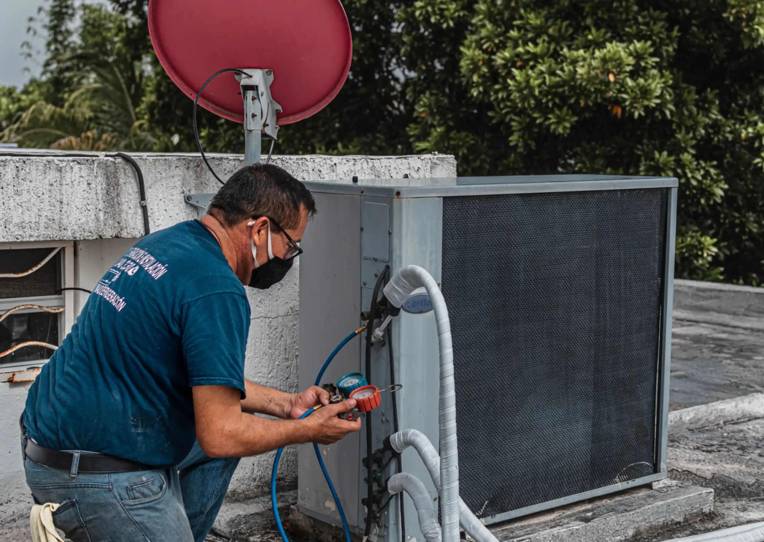 Technician working on an outdoor air conditioning system