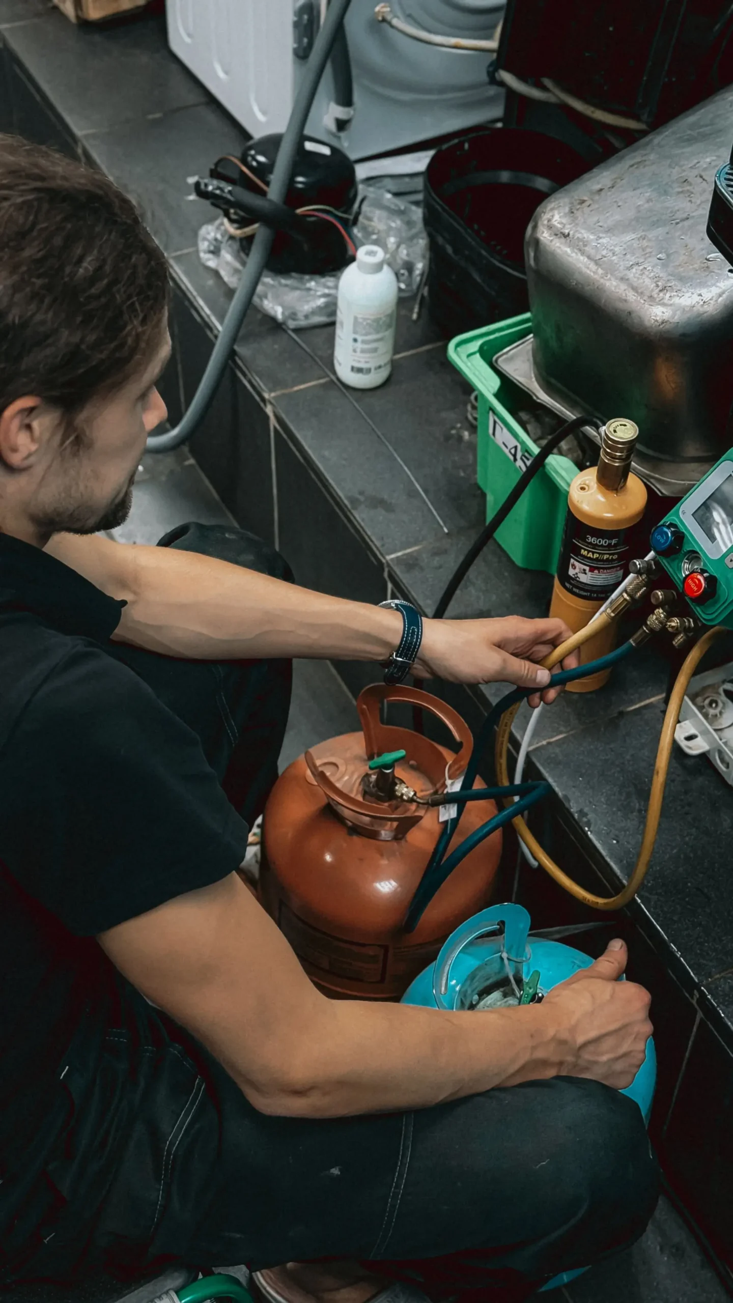 HVAC technician checking refrigerant system components during air conditioner service
